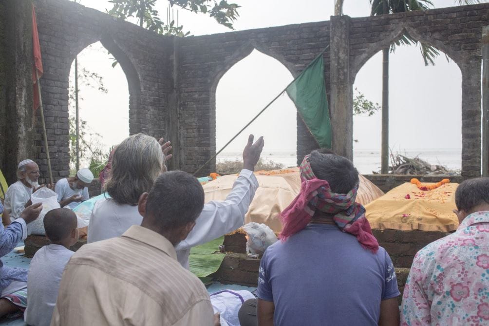 Locals praying at the shrine for protection from the Padma River.
