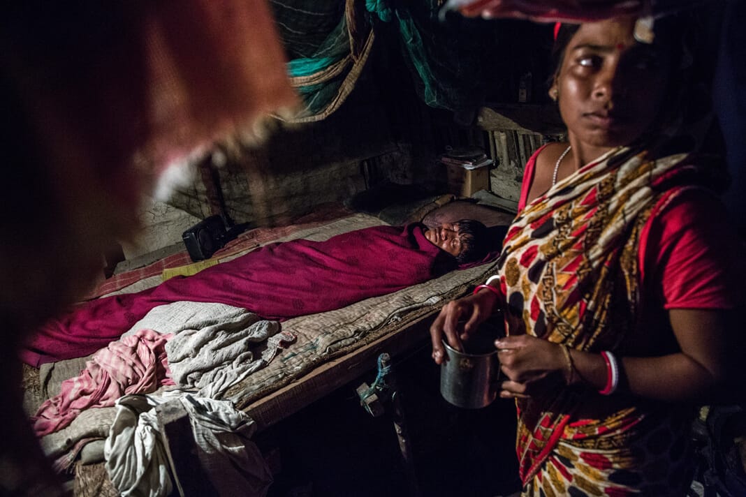 Laltu, 26, lies sick inside his home on Gosaba Island, Sundarbans, suffering from diarrhoea caused by contaminated drinking water.